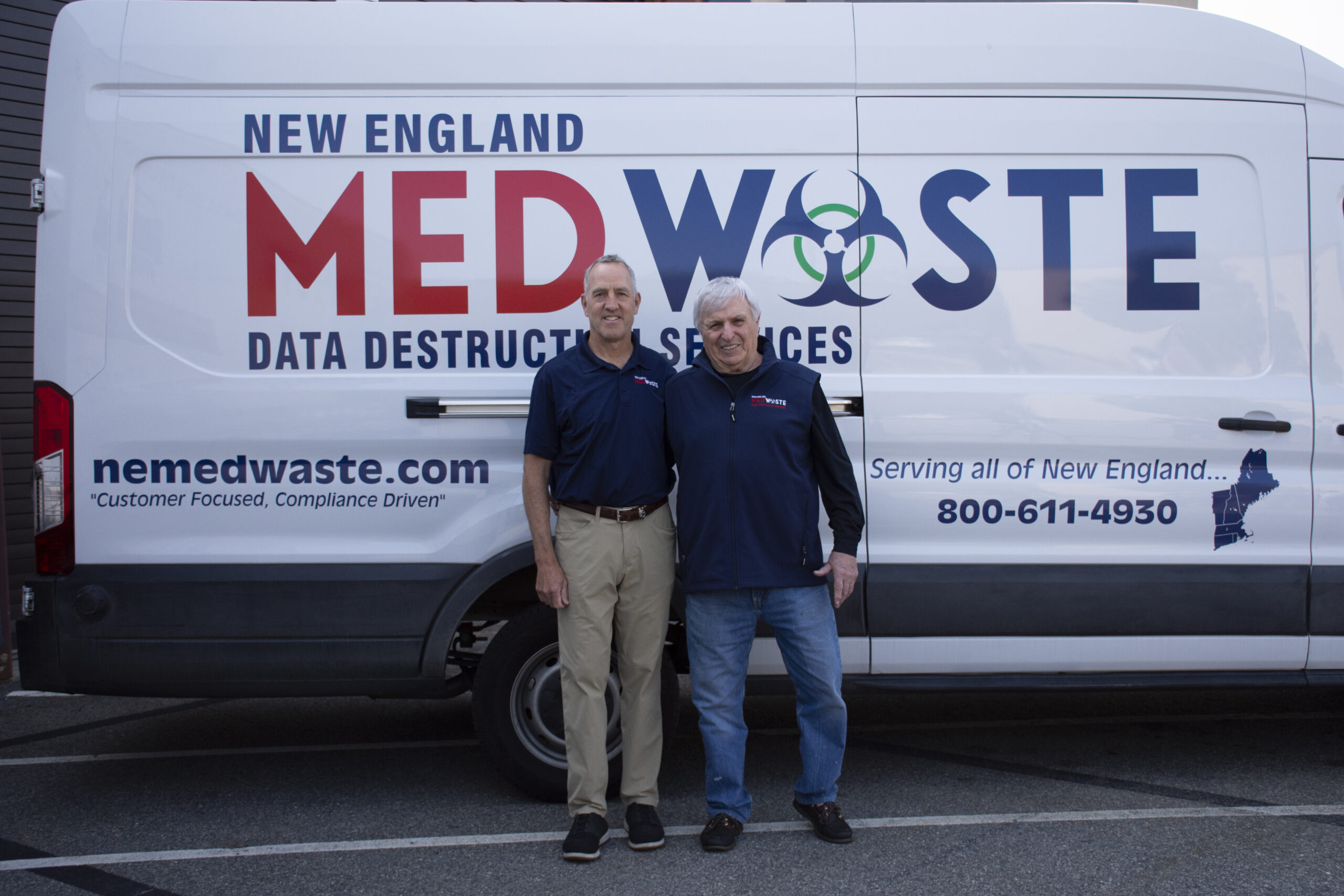 New England Medwaste truck logo two founders standing in front